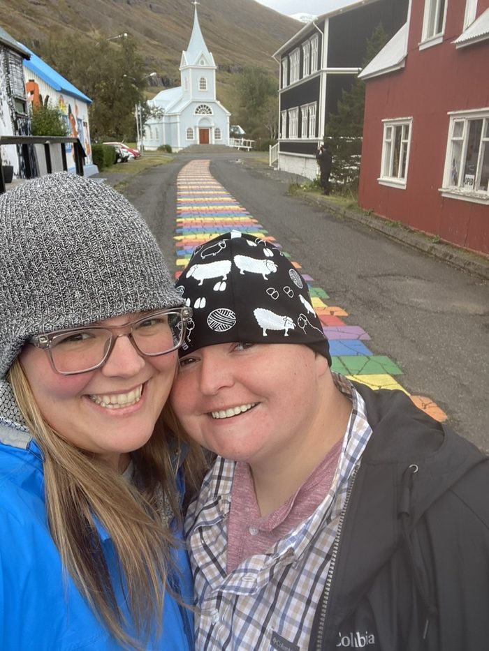 Amanda and Robyn on the rainbow street leading to the blue church in Sey&eth;isfj&ouml;r&eth;ur, Iceland.